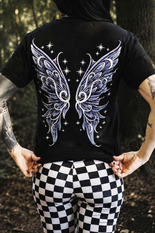 Person wearing a black t-shirt with fairy wings design outdoors