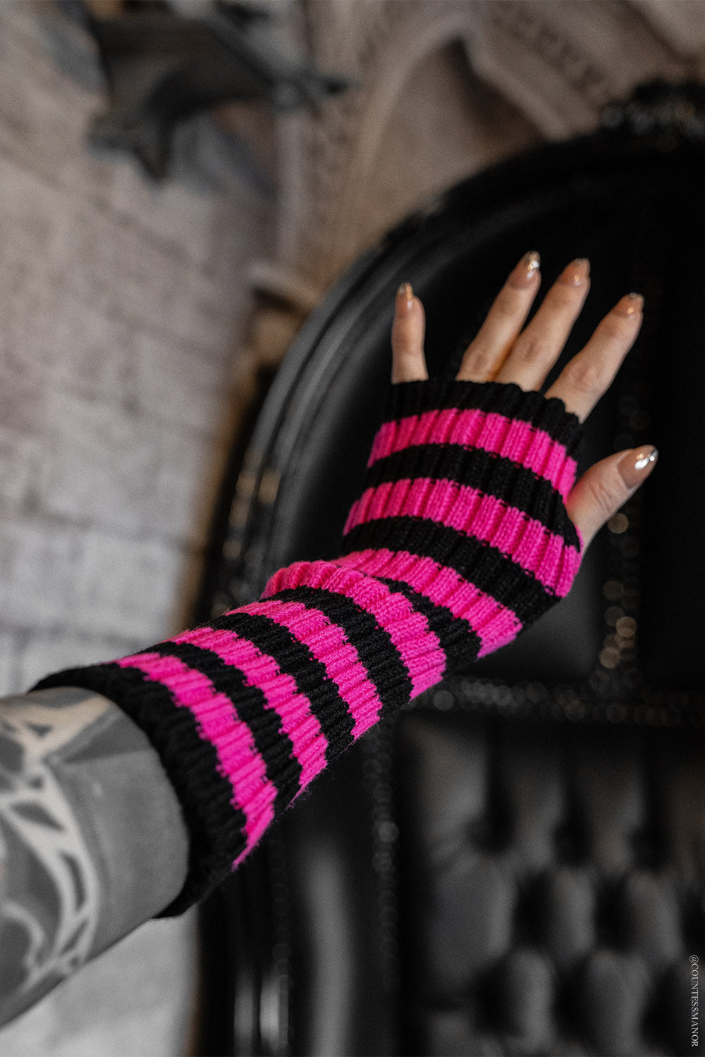 fingerless pink and black striped gloves