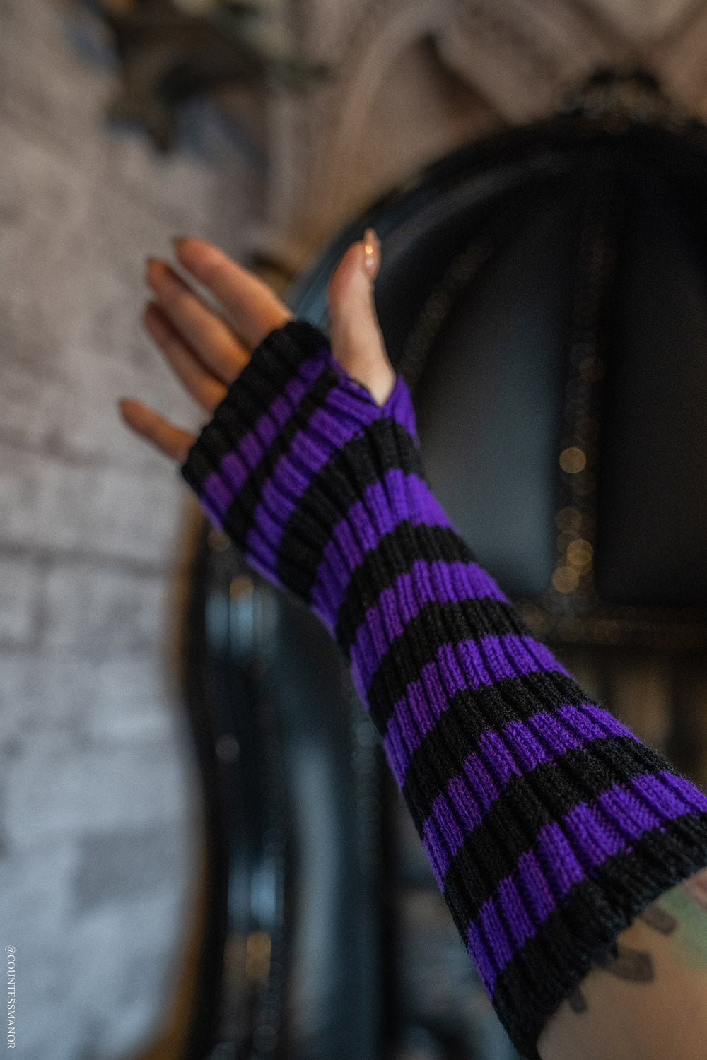 purple and black striped gloves