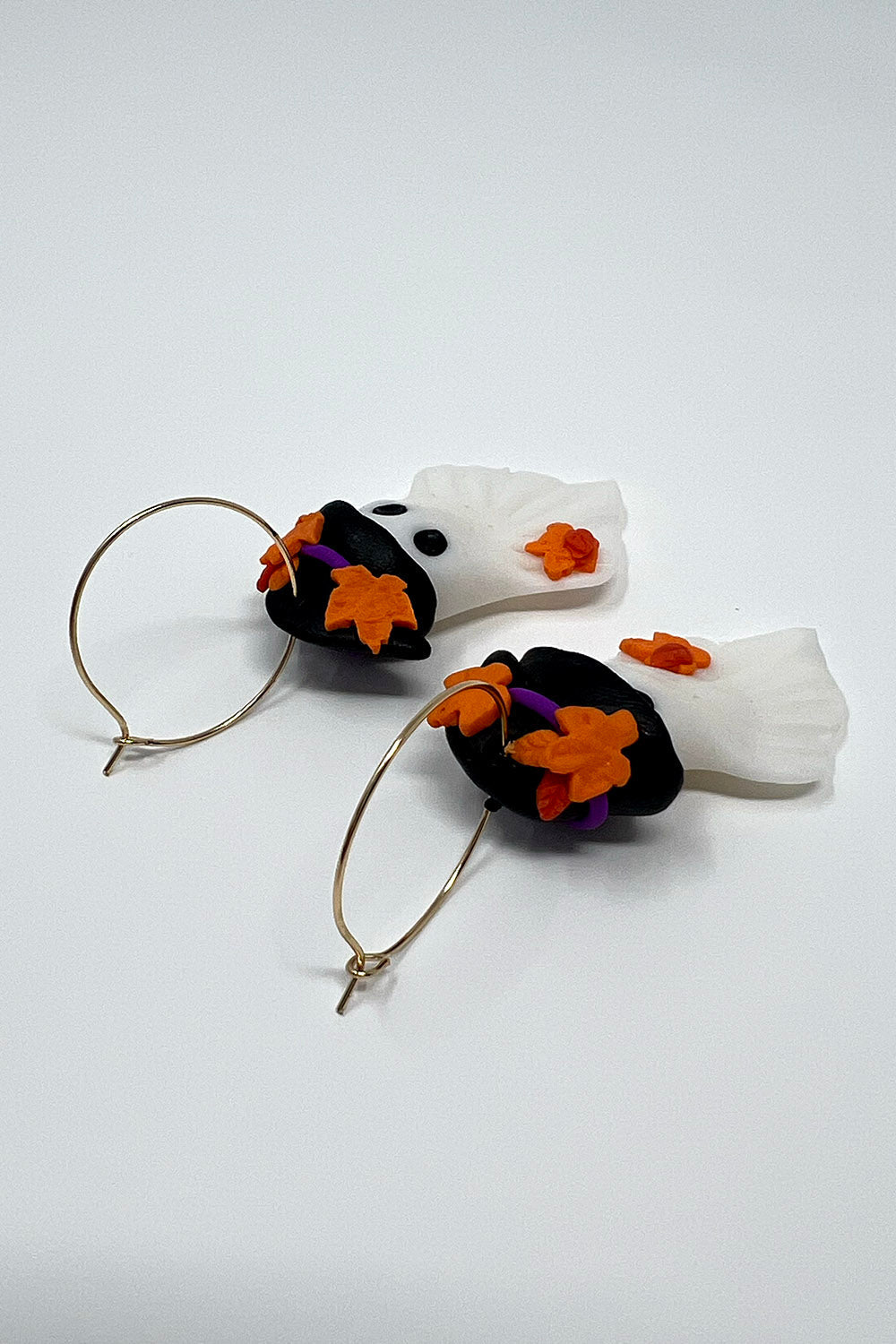 clay ghost earrings wearing witch hats with gold hoops